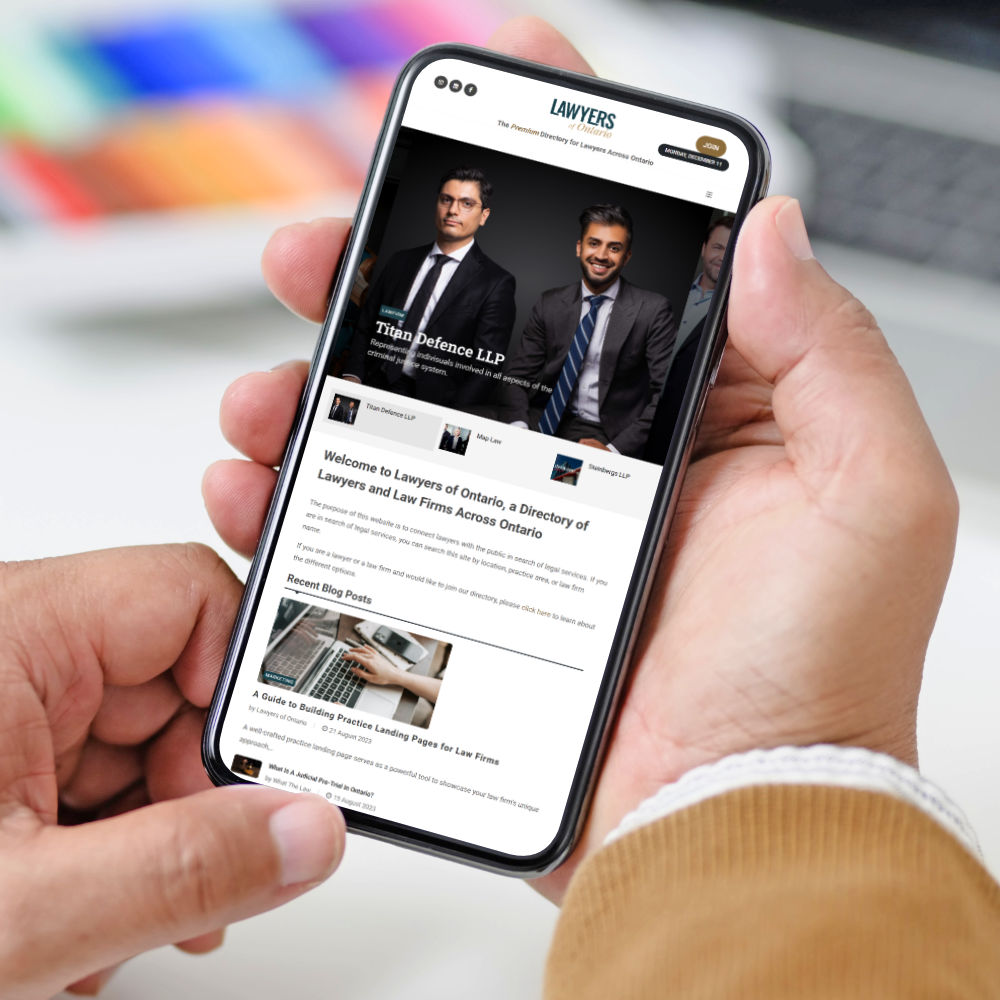 person holding phone showing Lawyers of Alberta website